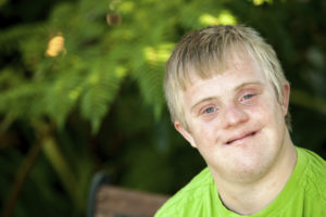 Boy with Down syndrome smiling