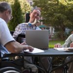 people in wheelchairs meeting in the community social