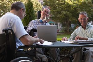 people in wheelchairs meeting in the community social