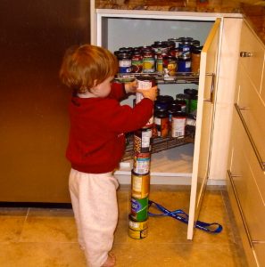 An autistic boy - autism - carefully stacks cans.